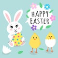 Easter greeting card. Cute rabbit bunny holding colored egg with dots and cute little yellow chicks in cracked eggs and Royalty Free Stock Photo