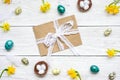 Easter greeting card with envelope in frame made of quail eggs, spring flowers and feathers