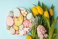 Easter greeting card with fresh tulip flowers, Gingerbread cookies - Easter eggs, chocken hen, bunny and flowers on white plate, Royalty Free Stock Photo