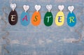 Easter greeting card made of Easter multi-colored paper eggs hanging on a rope with the inscription EASTER Royalty Free Stock Photo