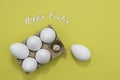 Happy Easter greeting white eggs in an egg carton and a toy baby chicken Royalty Free Stock Photo