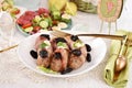 Easter grilled white sausage wrapped in bacon with prune and horseradish