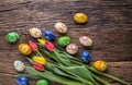 Easter. Hand made easter eggs and spring tulips on old wooden table