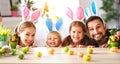Easter. happy family mother father and children are preparing for holiday home with eggs