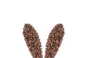 Easter holiday background with bunny ears made of freshly roasted coffee beans on a white background. Creative easter concept.