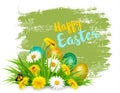 Easter Holiday Background with colofrul eggs in green grass and spring flowers.