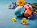 Easter holiday background with Easter eggs and tulip flowers on blue background. Royalty Free Stock Photo