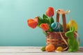 Easter holiday basket with eggs, flowers and Easter bunny