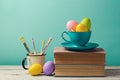 Easter holiday celebration with handmade painted eggs in coffee cup.