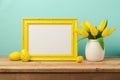 Easter holiday concept with blank photo frame and tulip flowers Royalty Free Stock Photo