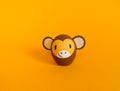 Easter holiday concept with cute handmade eggs: brown monkey