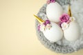 Easter holiday concept with cute handmade eggs, unicorn and flower decoration in bird nest