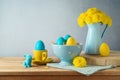 Easter holiday concept with Easter eggs, flowers and bunny decoration on wooden table