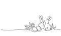 Easter holiday decoration. Rabbit, eggs on grass with flowers.