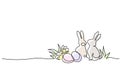 Easter holiday decoration. Rabbit, eggs on grass with flowers.