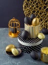 Easter holiday decorations with golden and black Easter eggs over elegant background