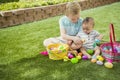 Two Cute little boys collecting eggs on an Easter Egg hunt outdoors Royalty Free Stock Photo