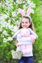 Easter holiday, little kid hug bunny. Spring and happy girl with pink ears. Royalty Free Stock Photo