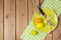 Easter holiday table setting with plate and eggs decoration on wooden background. Royalty Free Stock Photo