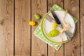 Easter holiday table setting with plate and eggs decoration on wooden background. Royalty Free Stock Photo