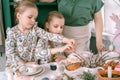 easter holiday time in spring season. happy family candid little kids sisters girls together mother have fun Royalty Free Stock Photo