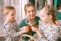 easter holiday time in spring season. happy family candid little kids sisters girls together mother mom have fun Royalty Free Stock Photo