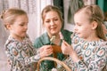 easter holiday time in spring season. happy family candid little kids sisters girls together mother mom have fun Royalty Free Stock Photo