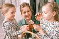 easter holiday time in spring season. happy family candid little kids sisters girls together mother mom have fun Royalty Free Stock Photo