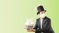 Man in a medical masks dressed as easter bunny with an easter bucket