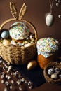 Easter holidays, cute basket with bunny ears on brown background. Easter cakes with colored sprinkles, colored golden eggs, and