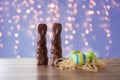 easter eggs in straw nest and chocolate bunnies Royalty Free Stock Photo