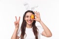 Easter, holidays and spring concept. Close-up portrait of cheerful, upbeat young woman in rabbit ears, bragging with her