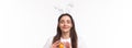 Easter, holidays and spring concept. Close-up portrait of dreamy charming young woman in rabbit ears, daydreaming close Royalty Free Stock Photo