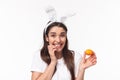 Easter, holidays and spring concept. Close-up portrait of silly and cute, happy giggling girl in rabbit ears, made her