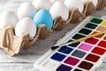 easter, holidays, tradition concept - close up of coloring easter eggs with colors and brush