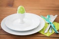 Easter egg in cup holder, plates and cutlery Royalty Free Stock Photo