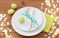 Easter egg in cup holder, plates and cutlery Royalty Free Stock Photo