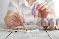 easter, holidays, tradition and people concept - close up of woman hands holding colored easter eggs