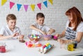 Happy family making Easter craft coloring eggs Royalty Free Stock Photo