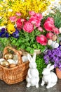 Easter home decoration with fresh spring flowers, bunny and eggs