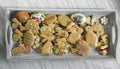 Easter homemade hand painted gingerbread cookies on grey wooden tray