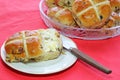 Easter hot cross buns. One cut in half. knife.
