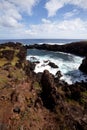 Easter Island rocky coast line under blue sky