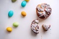 Easter Kraffin on a light background with colored, bright eggs. Cake with raisins, chocolate, nuts