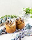 Easter kraffins on a background of colored eggs and cherry flowers. Easter story Royalty Free Stock Photo