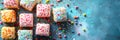 Easter lamingtons, coconut cakes on a blue background. Banner. Royalty Free Stock Photo