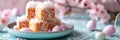 Easter lamingtons, coconut cakes on a blue background. Banner. Royalty Free Stock Photo