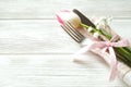 Easter laying table appointments, table setting options. Silverware, tableware items with festive decoration. Fork, knife and flow Royalty Free Stock Photo