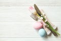 Easter laying table appointments, table setting options. Silverware, tableware items with festive decoration. Fork, knife and flow Royalty Free Stock Photo