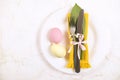 Easter laying table appointments, table setting options. Silverware, tableware items with festive decoration. Fork, knife and flow Royalty Free Stock Photo